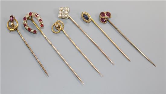 Six assorted mainly early 20th century yellow metal and gem set stick pins, including diamond set and one stamped 9ct.